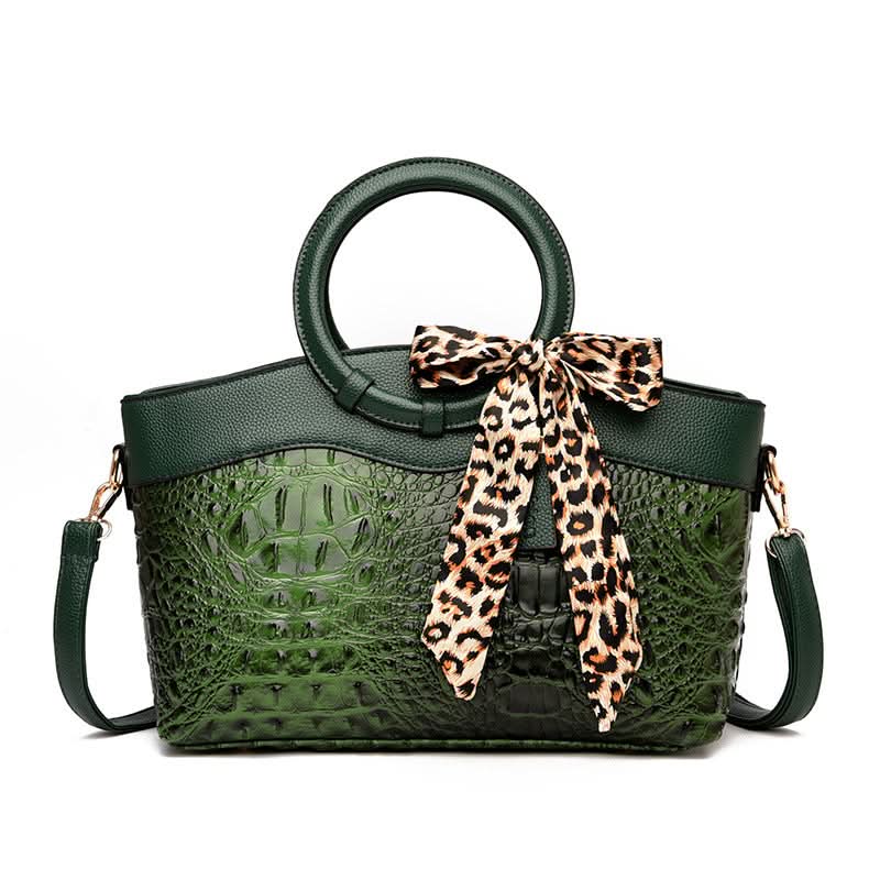 Handtasche mit Krokodilprägung und rundem Henkel