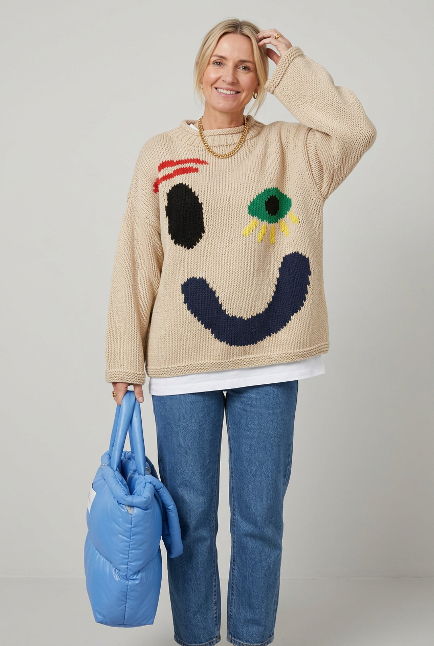 Beige smiley jumper alternate studio pose