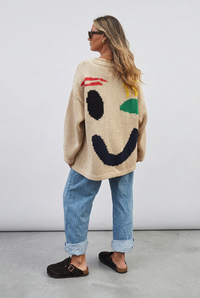 Beige smiley jumper back studio view