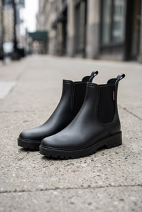 Black boots front angle on a sidewalk