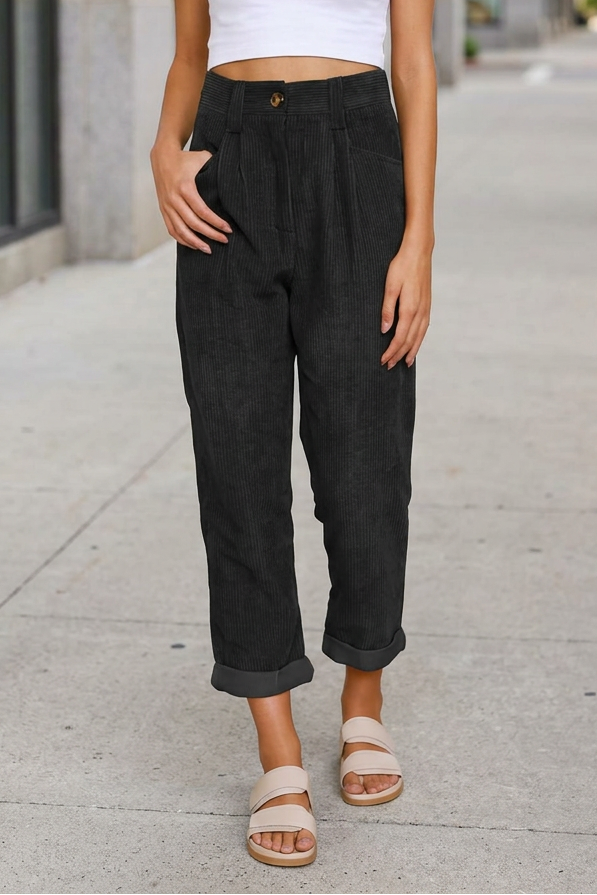 Black trousers on a sidewalk