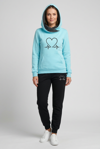 European woman wearing Aliya’s light-blue hoodie and black joggers