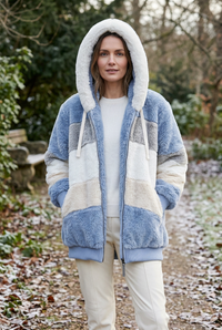 European woman wearing the blue Hattie jacket outdoors