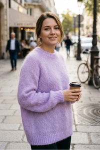European woman wearing the lilac crew-neck sweater on a sidewalk