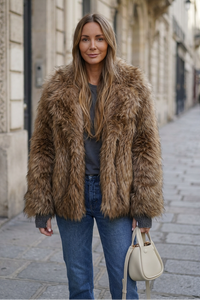 Front-facing sidewalk portrait wearing the faux-fur coat