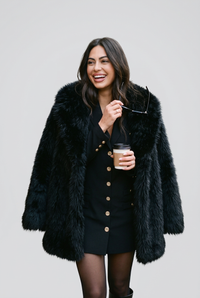 Kalyn black coat with coffee cup studio preview