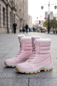 Pink boot pair on a sidewalk
